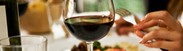 Glass of red wine at a diner's elegant place setting