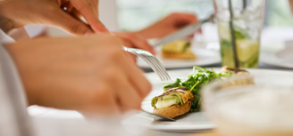 A diner cutting his food
